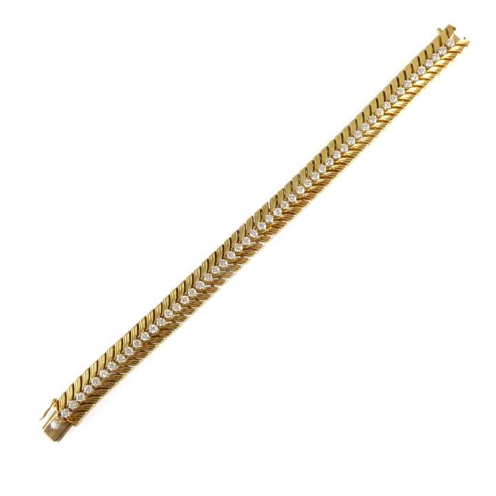 Gold and diamond set chevron strap bracelet by Cartier,